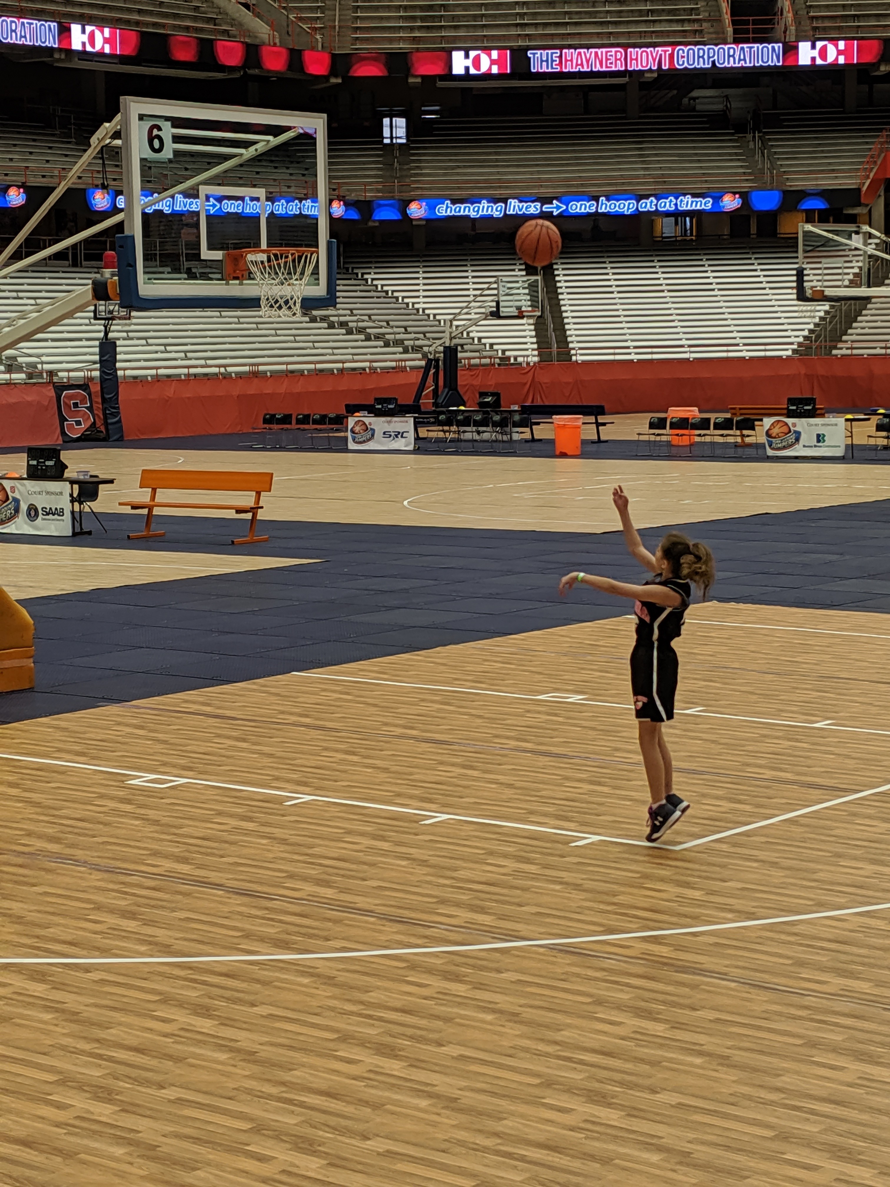 Bean shooting baskets in an empty arena.