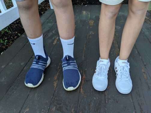 Scorch, wearing navy blue sneakers, and Bean, wearing white sneakers, on the first day of 8th and 6th grade.